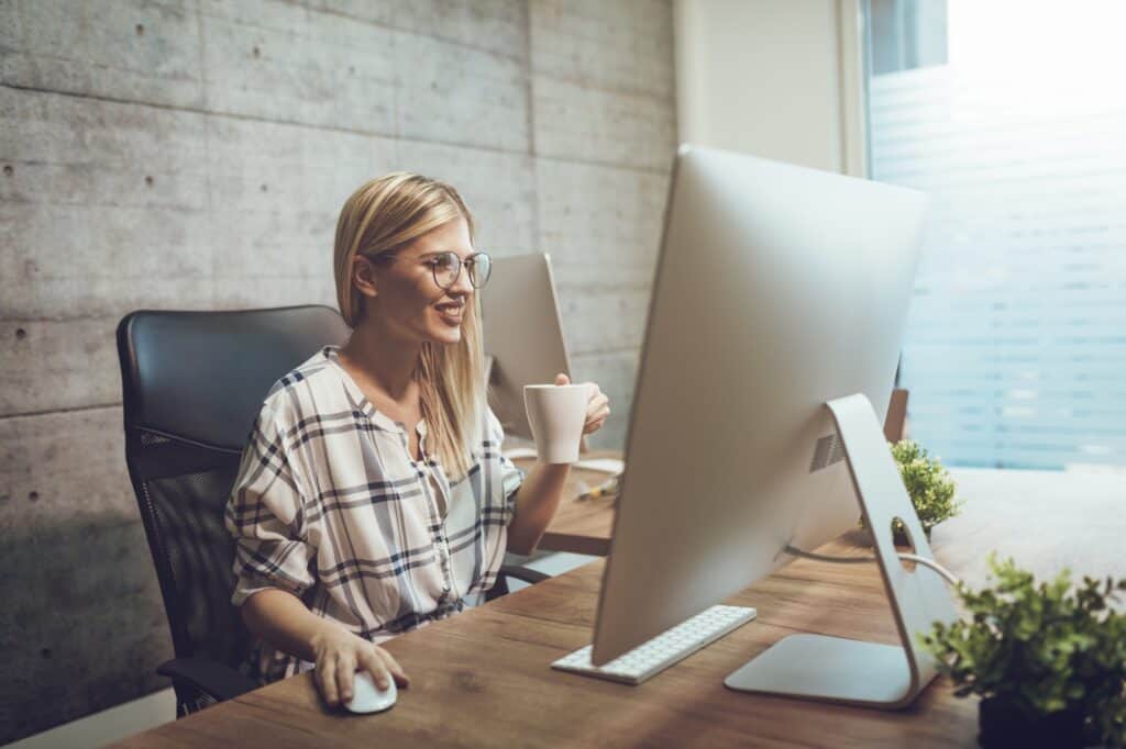 A female employee excitingly updates the company's social media accounts about the office move