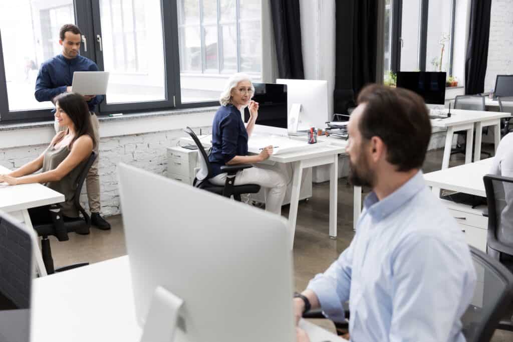 A small group of employees at the office in the concept of 'How to Minimise Disruption During an Office Move to Fulham'.