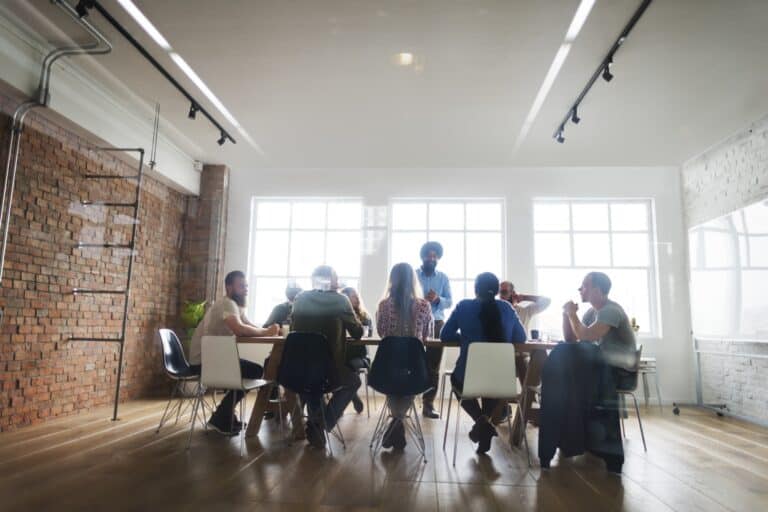 An in-person meeting with clients in the office's boardroom in the concept of 'How to Communicate an Office Move to Clients and Partners'.