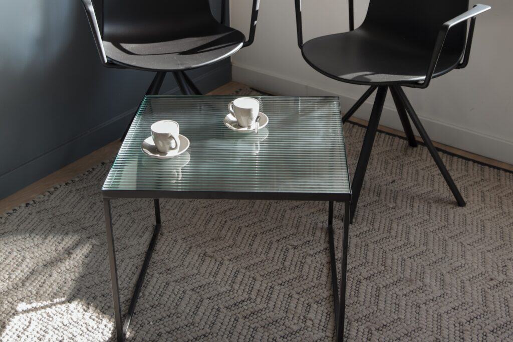 A closeup of a glass table and teacups in the office