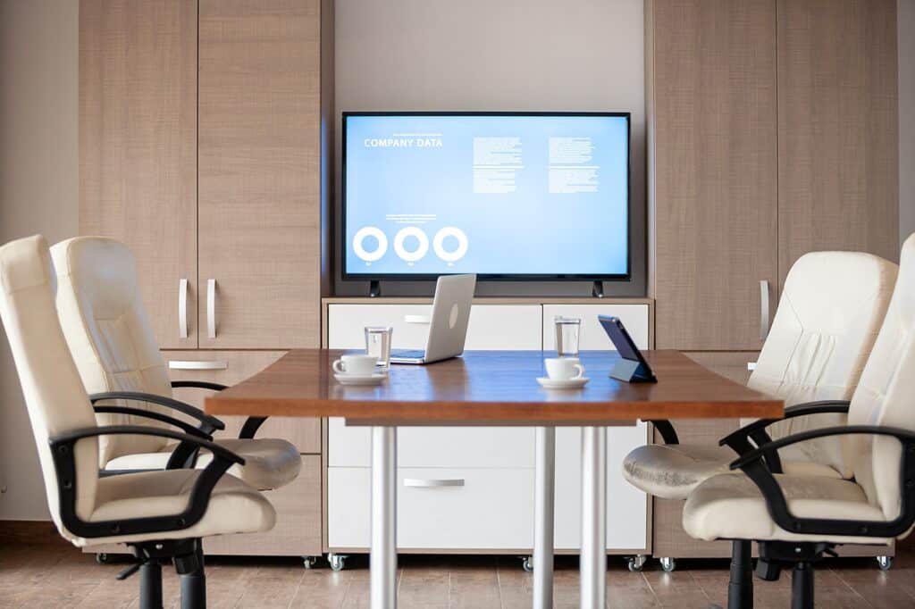 A large flat-screen TV in an office conference room