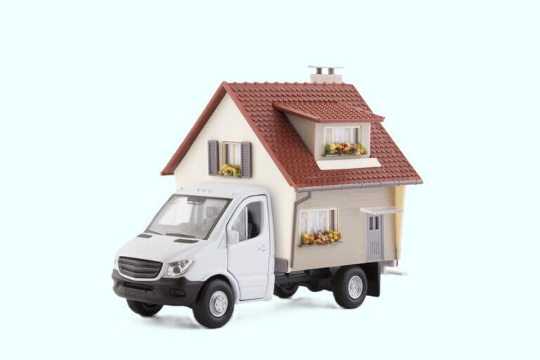 A house removal toy truck carrying a house in the concept of relocation